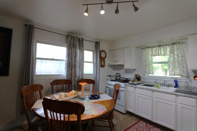 2016 Horeb Ave, Zion, IL 60099 - kitchen with a wealth of natural light, white range with gas cooktop, under cabinet range hood, and a sink