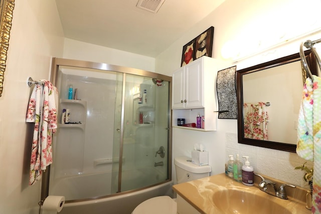 2016 Horeb Ave, Zion, IL 60099 - full bathroom with enclosed tub / shower combo, visible vents, toilet, vanity, and decorative backsplash