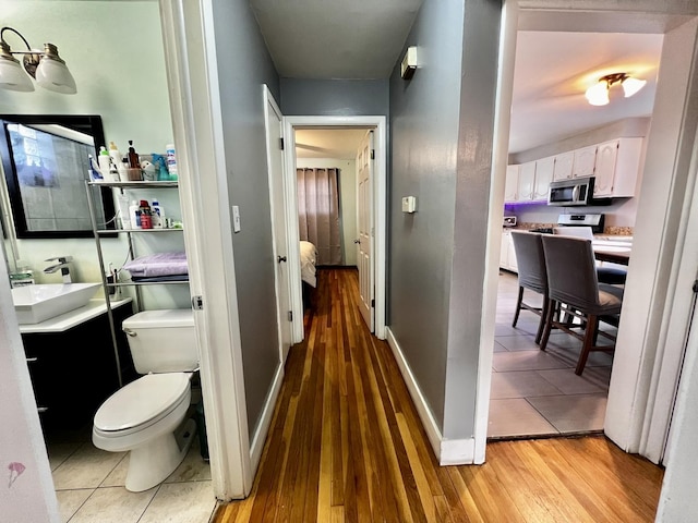 7971 S Kostner Ave, Chicago, IL 60652 - bathroom with toilet, vanity, wood finished floors, and baseboards
