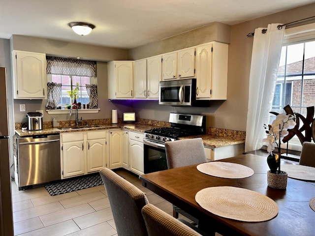 7971 S Kostner Ave, Chicago, IL 60652 - kitchen featuring white cabinets, stainless steel appliances, a sink, and a healthy amount of sunlight