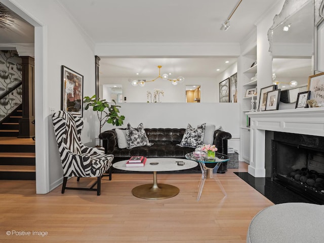 1343 N Sutton Pl, Chicago, IL 60610 - living room featuring crown molding, stairway, wood finished floors, a chandelier, and a fireplace