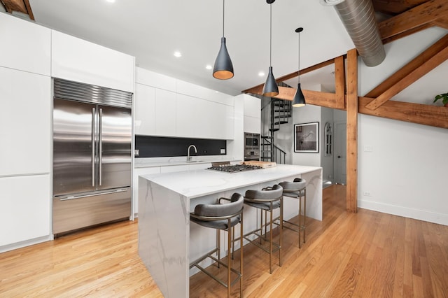 1547 N Leavitt St Unit 3S, Chicago, IL 60622 - kitchen with a sink, built in appliances, modern cabinets, white cabinetry, and recessed lighting