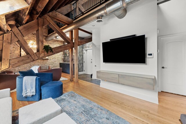 1547 N Leavitt St Unit 3S, Chicago, IL 60622 - living room featuring visible vents, baseboards, wood finished floors, and a towering ceiling