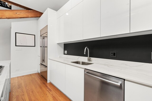 1547 N Leavitt St Unit 3S, Chicago, IL 60622 - kitchen featuring white cabinets, modern cabinets, appliances with stainless steel finishes, and a sink