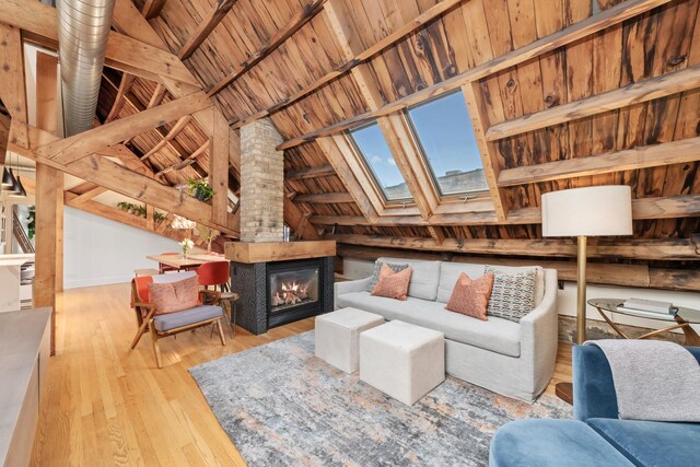 1547 N Leavitt St Unit 3S, Chicago, IL 60622 - living area with a glass covered fireplace, hardwood / wood-style flooring, vaulted ceiling with skylight, and wood ceiling