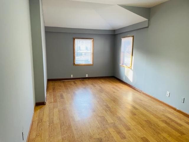 1218 Highland Ave, Joliet, IL 60435 - empty room with baseboards, lofted ceiling, and wood finished floors