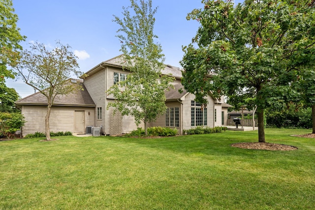 5632 Fairview Ave, Downers Grove, IL 60516 - back of property with a yard, central AC unit, roof with shingles, and a patio