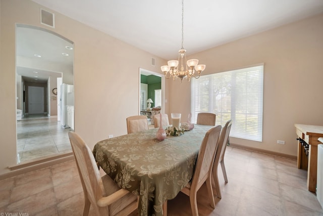 5632 Fairview Ave, Downers Grove, IL 60516 - dining area with arched walkways, a chandelier, and baseboards