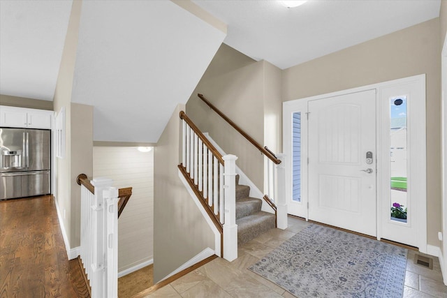 entryway with baseboards and visible vents