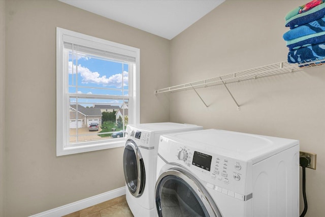 laundry area with separate washer and dryer, baseboards, and laundry area