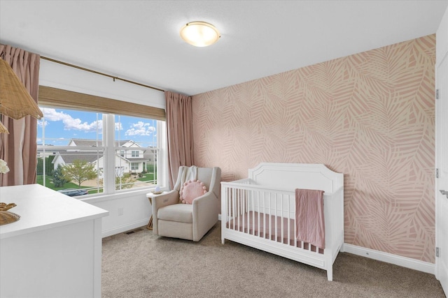 bedroom featuring visible vents, baseboards, wallpapered walls, light colored carpet, and a nursery area