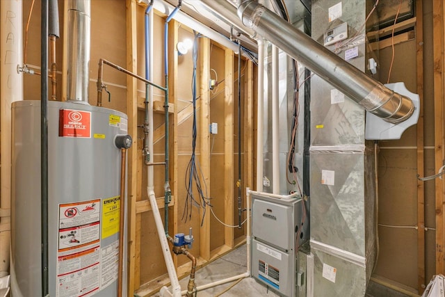 utility room with heating unit and water heater
