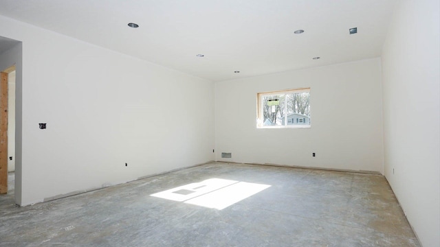 empty room with unfinished concrete flooring