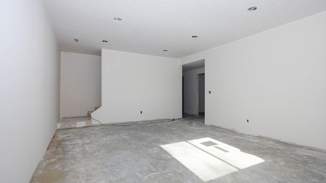 unfurnished room featuring unfinished concrete flooring