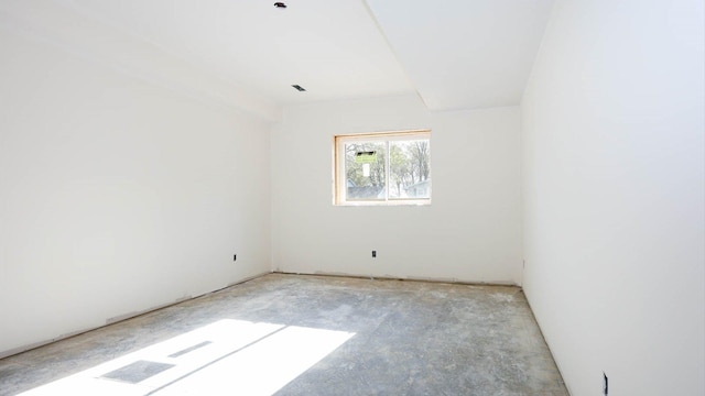 spare room with unfinished concrete flooring