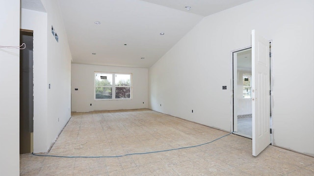 spare room featuring lofted ceiling