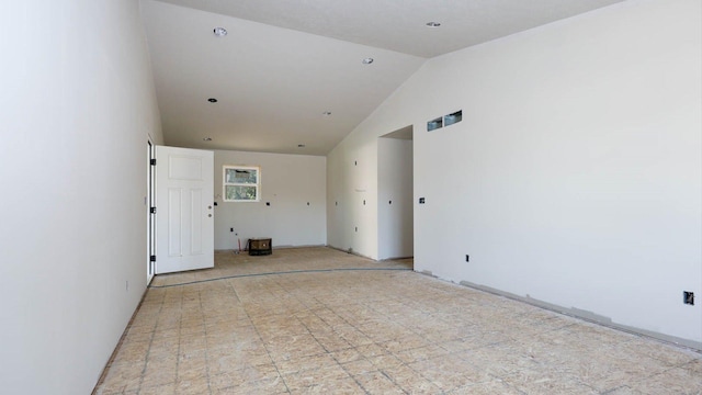 unfurnished room featuring lofted ceiling