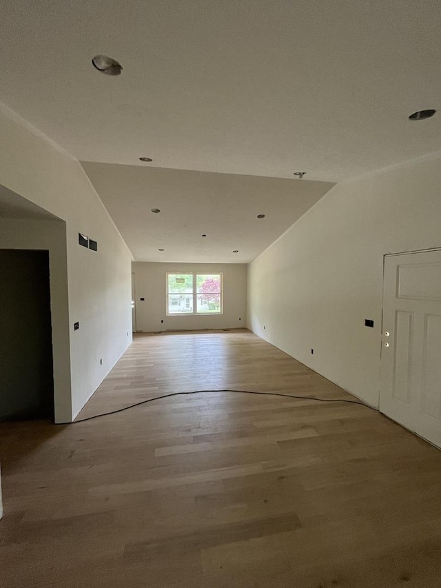 unfurnished room featuring light wood-style floors, lofted ceiling, and recessed lighting