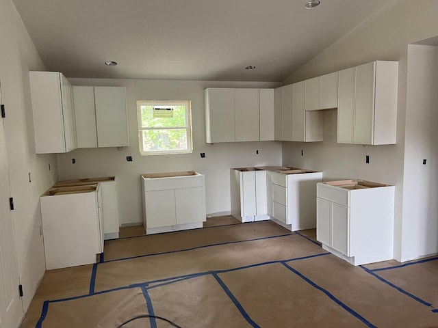 kitchen featuring vaulted ceiling and recessed lighting