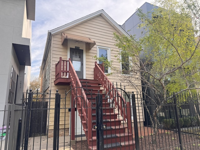 view of front facade with a fenced front yard and a gate