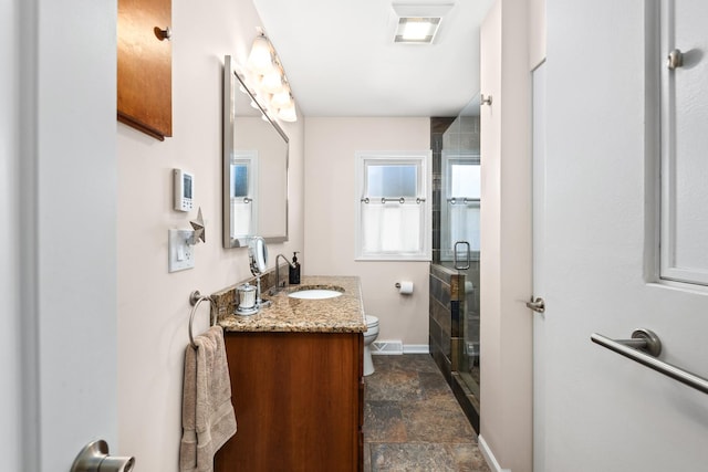736 Willow Rd, Naperville, IL 60540 - full bathroom with vanity, stone tile floors, toilet, baseboards, and a stall shower