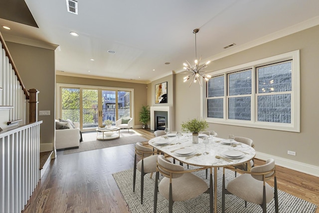 dining space featuring baseboards, visible vents, and wood finished floors