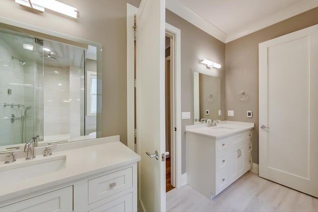 bathroom with vanity, baseboards, and a stall shower