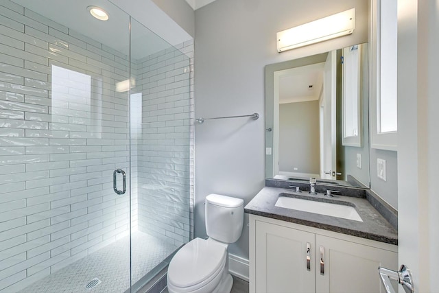 full bathroom with vanity, a shower stall, and toilet