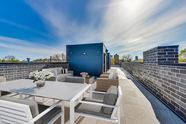 view of patio featuring an outbuilding, outdoor dining area, and an outdoor hangout area