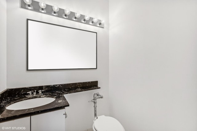 bathroom featuring toilet and vanity