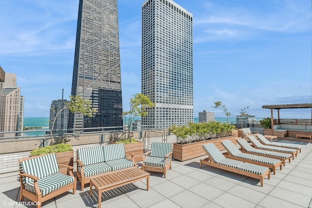 view of patio / terrace featuring a water view and a view of city