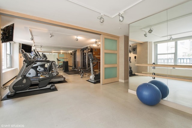 exercise room featuring rail lighting