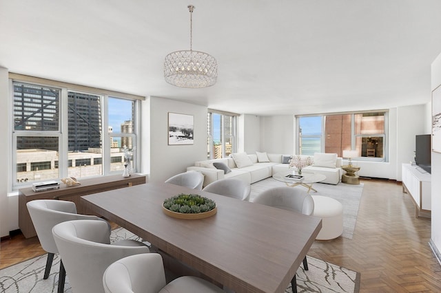 dining space featuring a chandelier and plenty of natural light