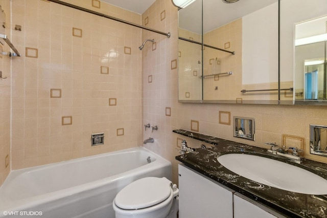 full bath featuring vanity, shower / tub combination, tile walls, and toilet