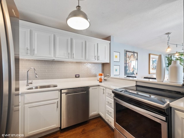 3660 N Lake Shore Dr Unit 3905, Chicago, IL 60613 - kitchen featuring appliances with stainless steel finishes, a sink, decorative backsplash, white cabinetry, and a textured ceiling