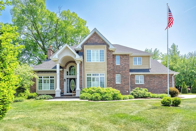 127 60th St, Downers Grove, IL 60516 - traditional home featuring brick siding, a shingled roof, and a front yard