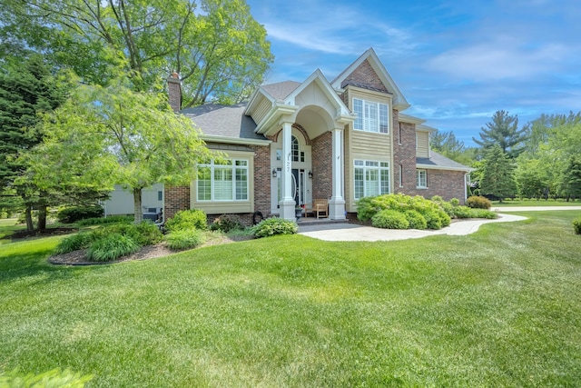 127 60th St, Downers Grove, IL 60516 - view of front of property with a front lawn, a chimney, brick siding, and a shingled roof