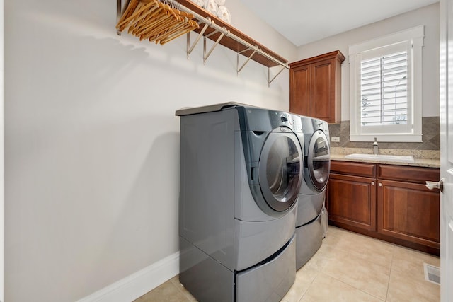 127 60th St, Downers Grove, IL 60516 - laundry room with washer and clothes dryer, cabinet space, light tile patterned floors, and baseboards