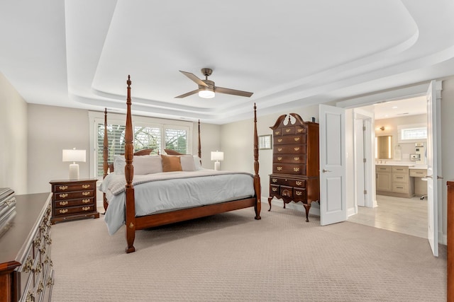 127 60th St, Downers Grove, IL 60516 - bedroom featuring a tray ceiling, light carpet, ensuite bath, and ceiling fan