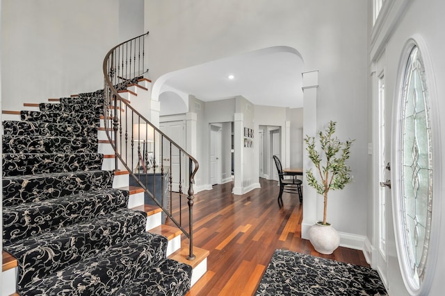 127 60th St, Downers Grove, IL 60516 - entrance foyer featuring arched walkways, a towering ceiling, wood finished floors, stairs, and baseboards