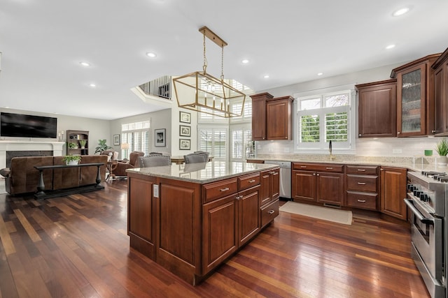 127 60th St, Downers Grove, IL 60516 - kitchen featuring appliances with stainless steel finishes, open floor plan, dark wood-style floors, light stone countertops, and glass insert cabinets
