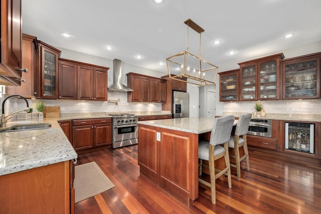 127 60th St, Downers Grove, IL 60516 - kitchen with stainless steel appliances, wall chimney exhaust hood, wine cooler, a sink, and a center island