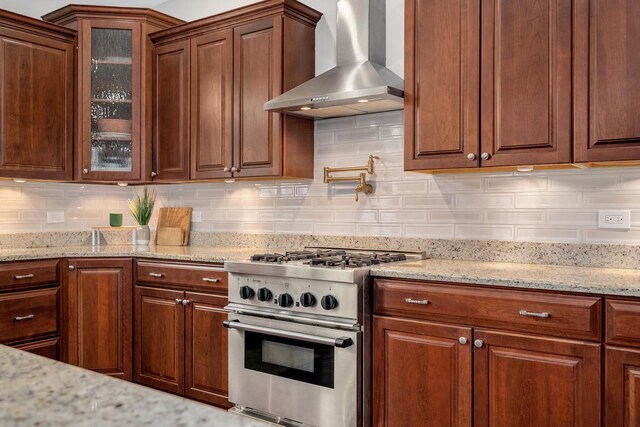 127 60th St, Downers Grove, IL 60516 - kitchen with high end stove, wall chimney range hood, glass insert cabinets, light stone countertops, and tasteful backsplash