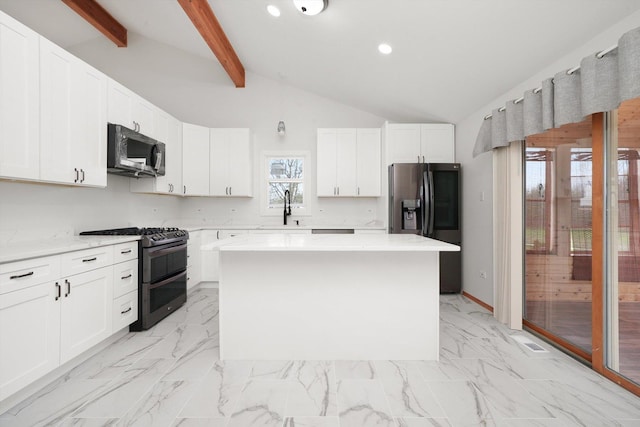kitchen featuring a kitchen island, stainless steel appliances, white cabinets, and a sink