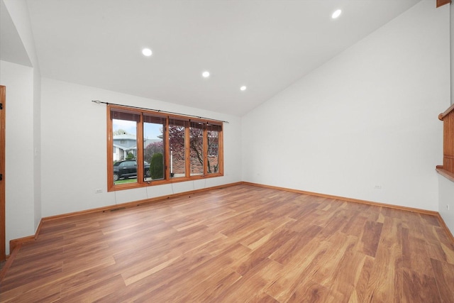 interior space with baseboards, vaulted ceiling, recessed lighting, and light wood-style flooring
