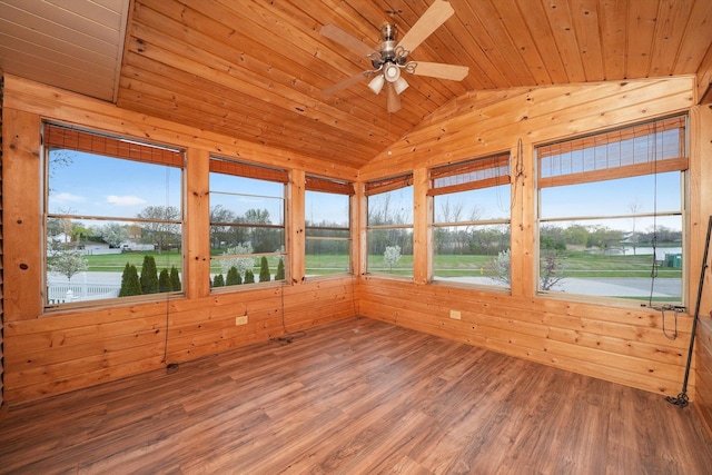 unfurnished sunroom featuring wood ceiling, wood finished floors, vaulted ceiling, and wooden walls