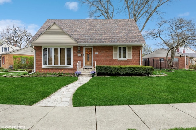 view of front of house with a front lawn and brick siding