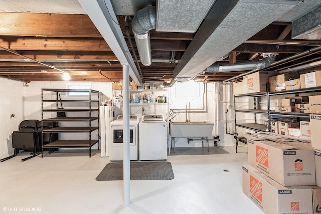 below grade area featuring a sink and washing machine and dryer