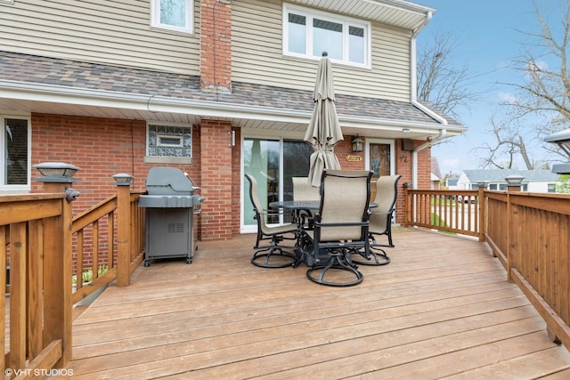 deck featuring area for grilling and outdoor dining area