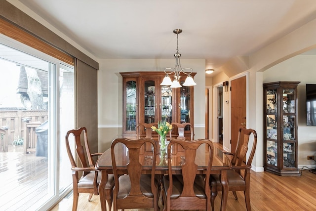 dining room with an inviting chandelier and light wood-style floors